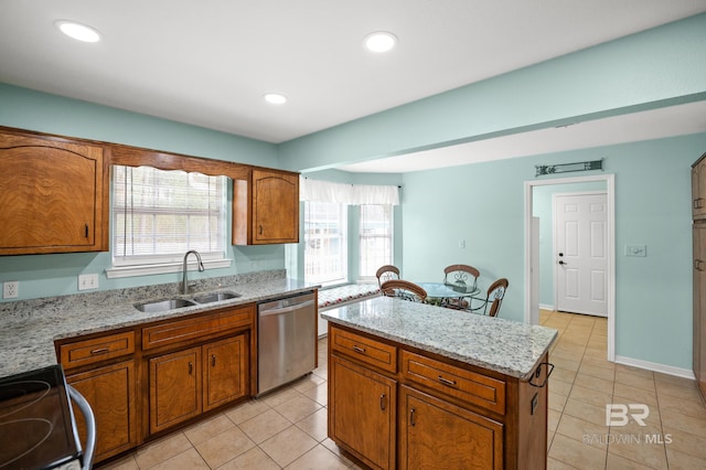 2553 Santa Rosa Dr, Lillian, AL 36549 - kitchen featuring stainless steel dishwasher, a sink, brown cabinetry, light tile patterned flooring, and recessed lighting
