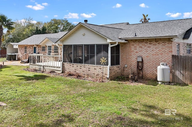 2553 Santa Rosa Dr, Lillian, AL 36549 - rear view of property with brick siding, a sunroom, and a shingled roof