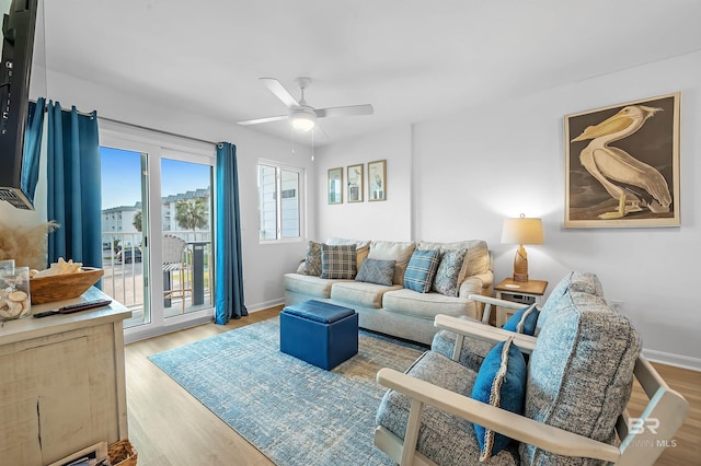 living room with light hardwood / wood-style floors and ceiling fan