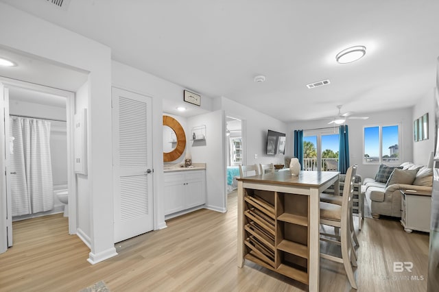 dining room featuring ceiling fan and light hardwood / wood-style flooring