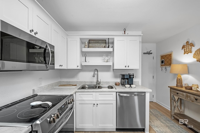 kitchen featuring sink, stainless steel appliances, and white cabinets