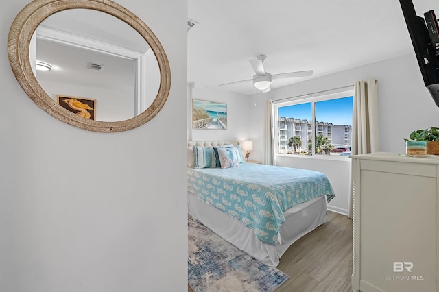 bedroom with ceiling fan and light hardwood / wood-style flooring