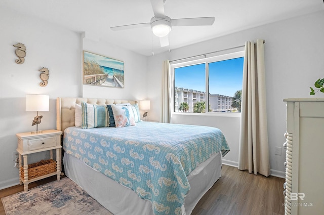 bedroom with ceiling fan and hardwood / wood-style flooring