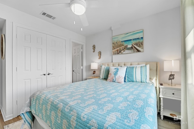 bedroom featuring light hardwood / wood-style floors, ceiling fan, and a closet