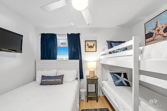 bedroom with light hardwood / wood-style floors and ceiling fan