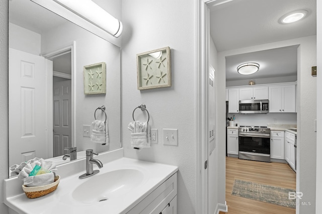 bathroom with vanity and hardwood / wood-style floors