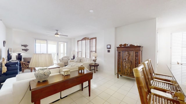 living room featuring light tile patterned floors and ceiling fan