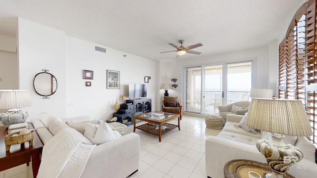 living room featuring light tile patterned floors and ceiling fan