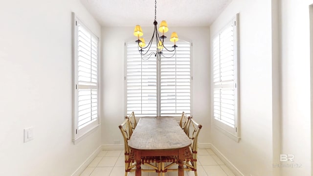 tiled dining space with an inviting chandelier and a textured ceiling