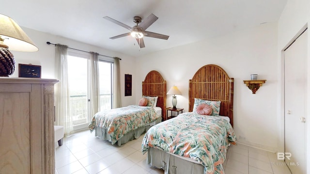 tiled bedroom featuring ceiling fan