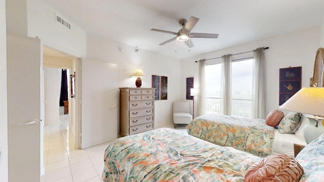 bedroom with ceiling fan and light tile patterned flooring