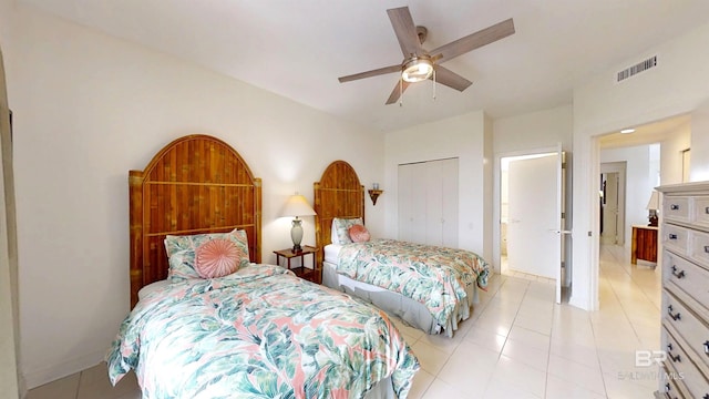 tiled bedroom with a closet and ceiling fan