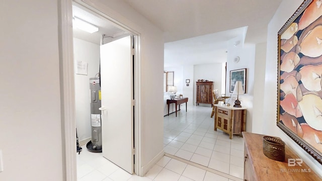 corridor with electric water heater and light tile patterned floors