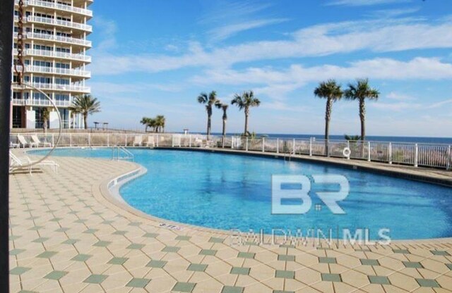 view of pool featuring a water view