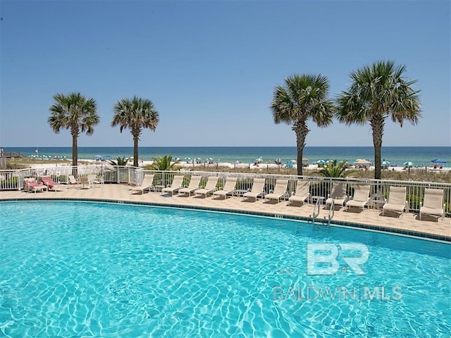 view of swimming pool with a water view