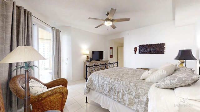 tiled bedroom featuring ceiling fan