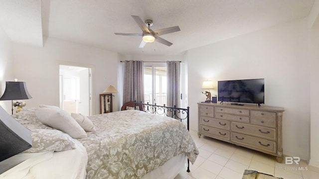 bedroom featuring light tile patterned floors, ceiling fan, and ensuite bath