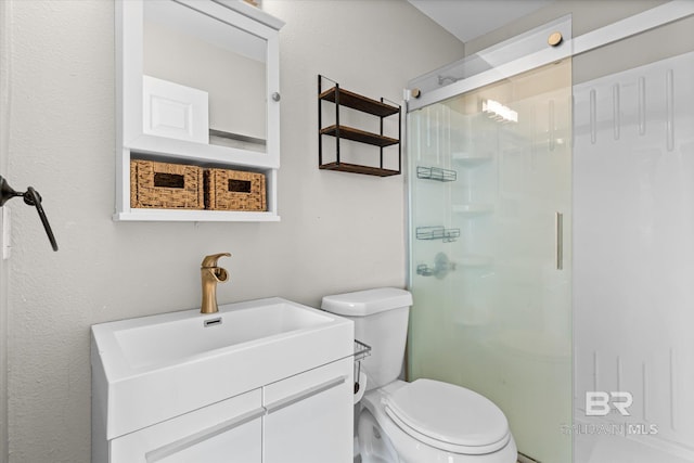 full bathroom with vanity, a shower stall, and toilet