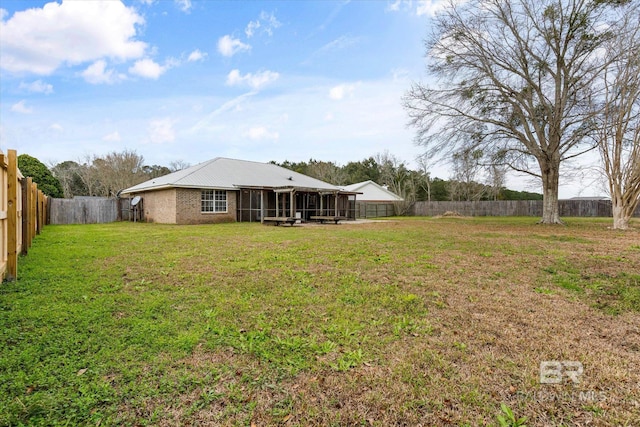 view of yard featuring a fenced backyard and a sunroom