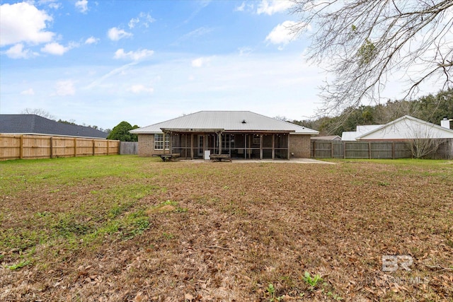 back of house with a patio, a lawn, a fenced backyard, and a sunroom