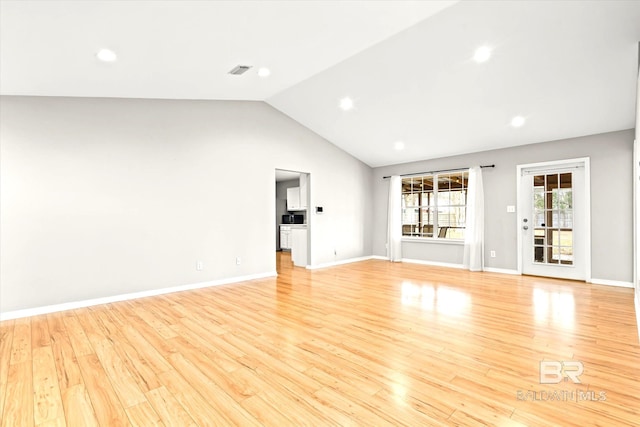 unfurnished living room featuring vaulted ceiling, visible vents, baseboards, and light wood finished floors