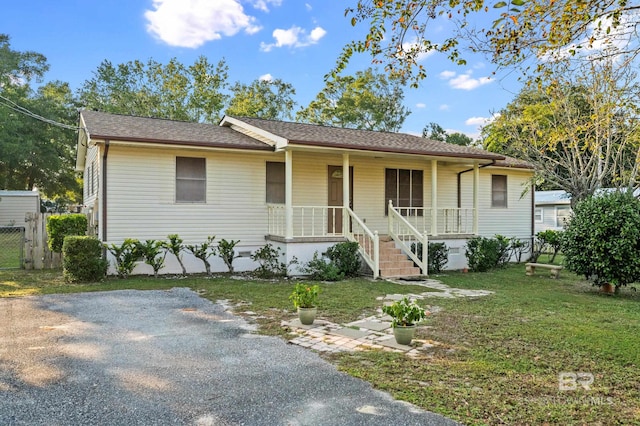 view of front of home with a porch and a front yard