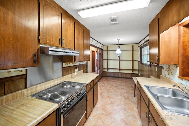 kitchen with exhaust hood, black range with electric cooktop, sink, pendant lighting, and a textured ceiling