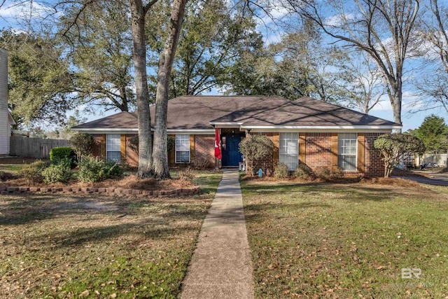 single story home with brick siding, a front yard, and fence