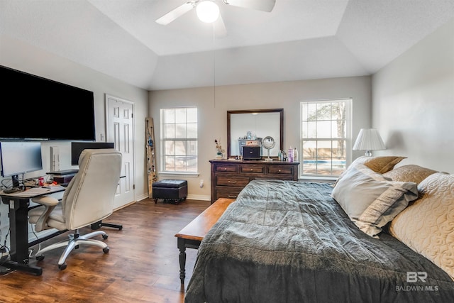 bedroom with lofted ceiling, ceiling fan, baseboards, and wood finished floors