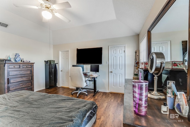 bedroom with lofted ceiling, ceiling fan, wood finished floors, visible vents, and baseboards