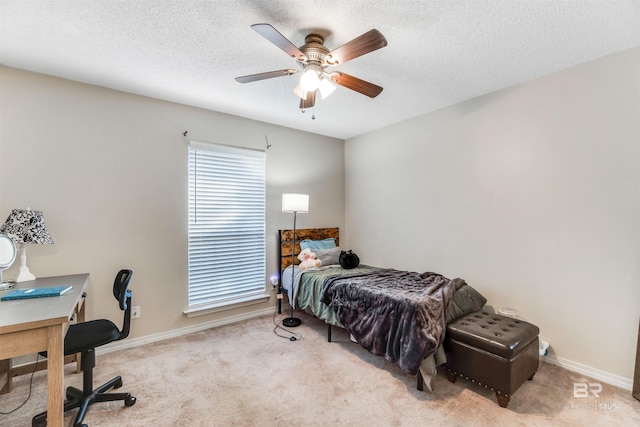 bedroom featuring a ceiling fan, carpet, a textured ceiling, and baseboards