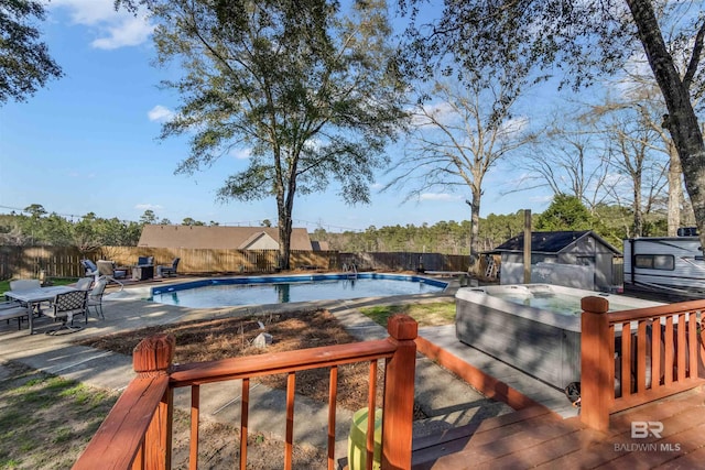 view of pool with a fenced backyard, a jacuzzi, a fenced in pool, and a patio