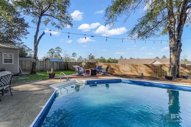 view of swimming pool featuring a patio area, a fenced backyard, and a fenced in pool