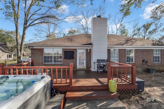 deck with fence, a grill, and a hot tub