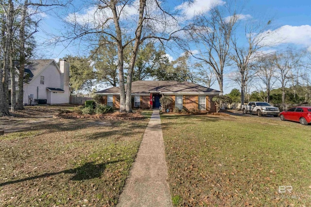 view of front of house with brick siding and a front lawn