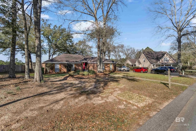 view of front of house featuring driveway and fence