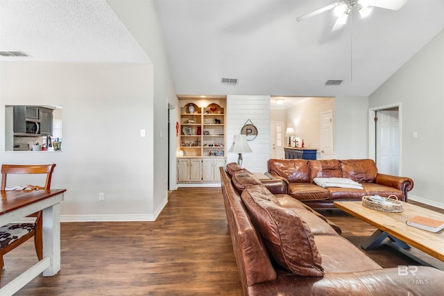 living area with visible vents, vaulted ceiling, and dark wood-type flooring