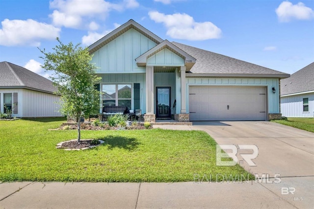 view of front facade with board and batten siding, a shingled roof, a front lawn, concrete driveway, and a garage