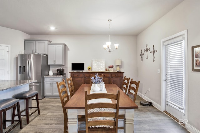 dining room featuring recessed lighting, baseboards, a chandelier, and light wood finished floors