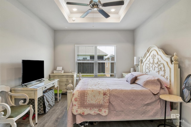 bedroom featuring crown molding, recessed lighting, wood finished floors, a raised ceiling, and a ceiling fan