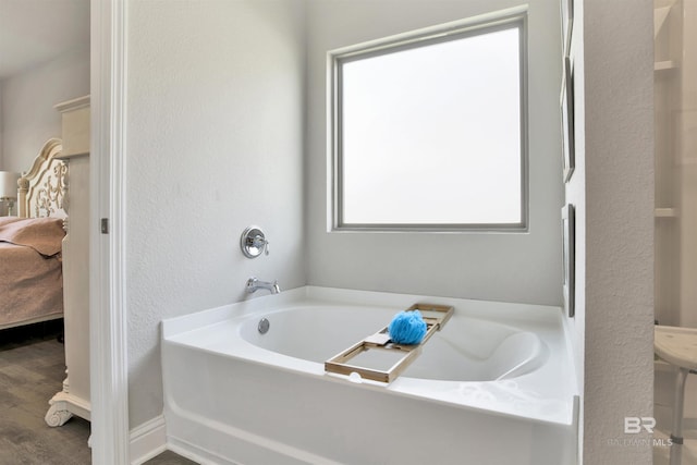 full bath with a bath, ensuite bathroom, and wood finished floors