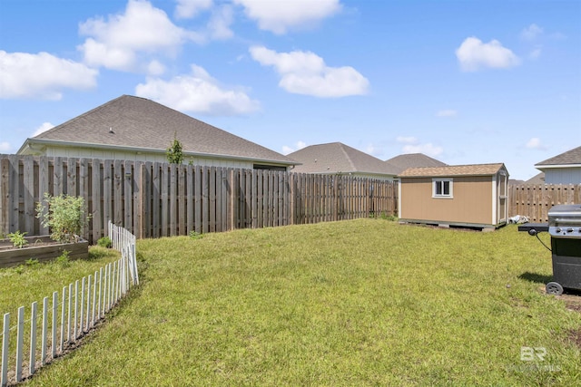 view of yard featuring a fenced backyard, a storage shed, a vegetable garden, and an outdoor structure