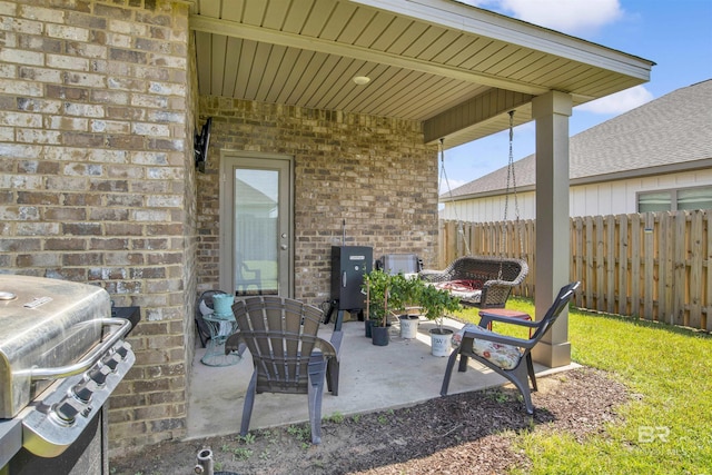 view of patio featuring area for grilling and fence