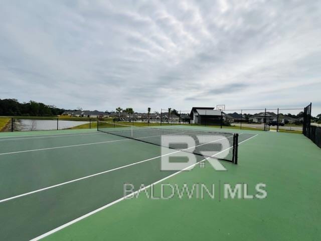 view of home's community featuring a tennis court and fence