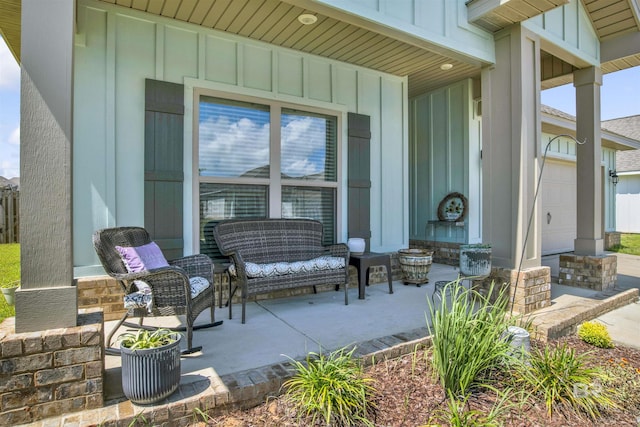 view of patio featuring a porch and a garage