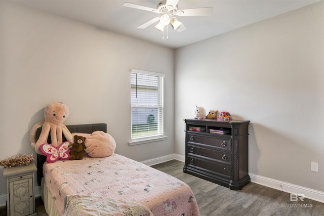 bedroom with ceiling fan, baseboards, and wood finished floors