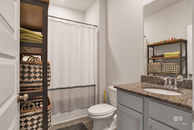 bathroom featuring vanity, toilet, and a shower with curtain