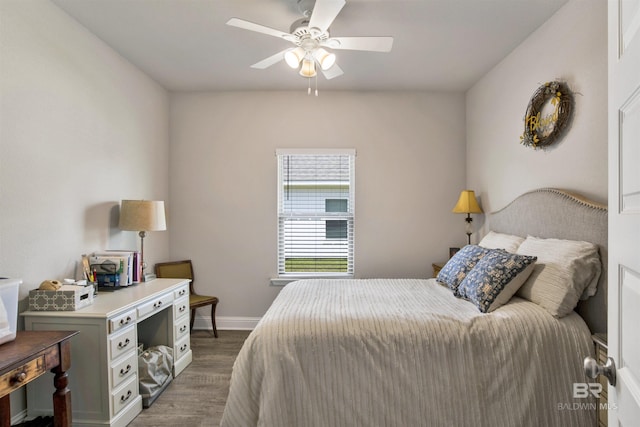 bedroom featuring wood finished floors, baseboards, and ceiling fan