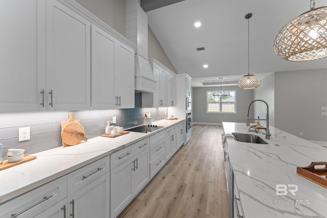 LOT9 Tall Timber Ln, Elberta, AL 36530 - kitchen with black electric stovetop, white cabinetry, light wood finished floors, tasteful backsplash, and vaulted ceiling