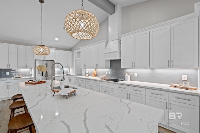 LOT9 Tall Timber Ln, Elberta, AL 36530 - kitchen featuring vaulted ceiling, stainless steel fridge, black electric cooktop, a spacious island, and backsplash